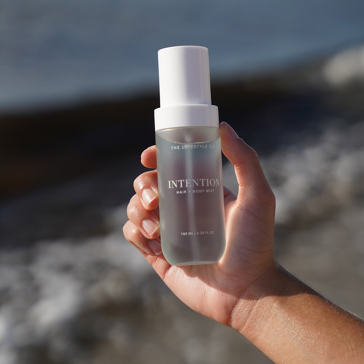 Close-up of The Lyfestyle Co. Intention Hair & Body Mist bottle held in one hand.
