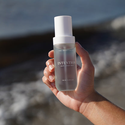 Close-up of The Lyfestyle Co. Intention Hair & Body Mist bottle held in one hand.